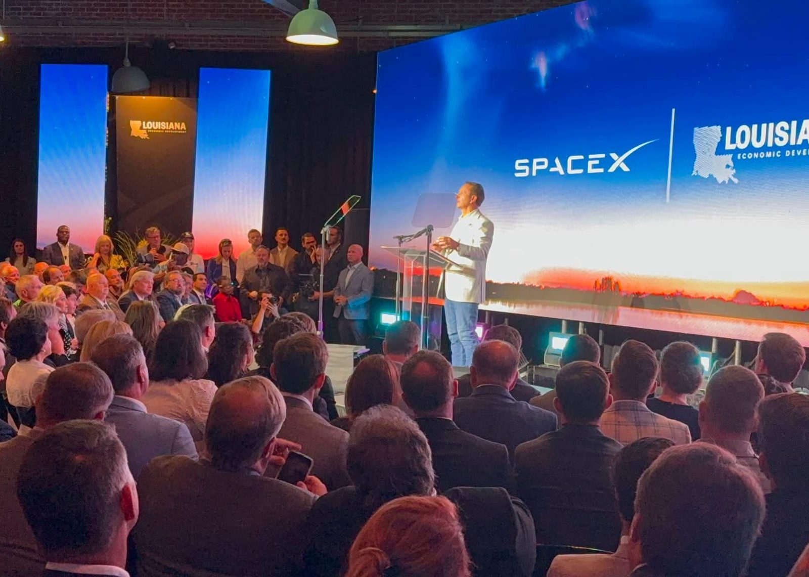 Audience and stage at a corporate announcement
