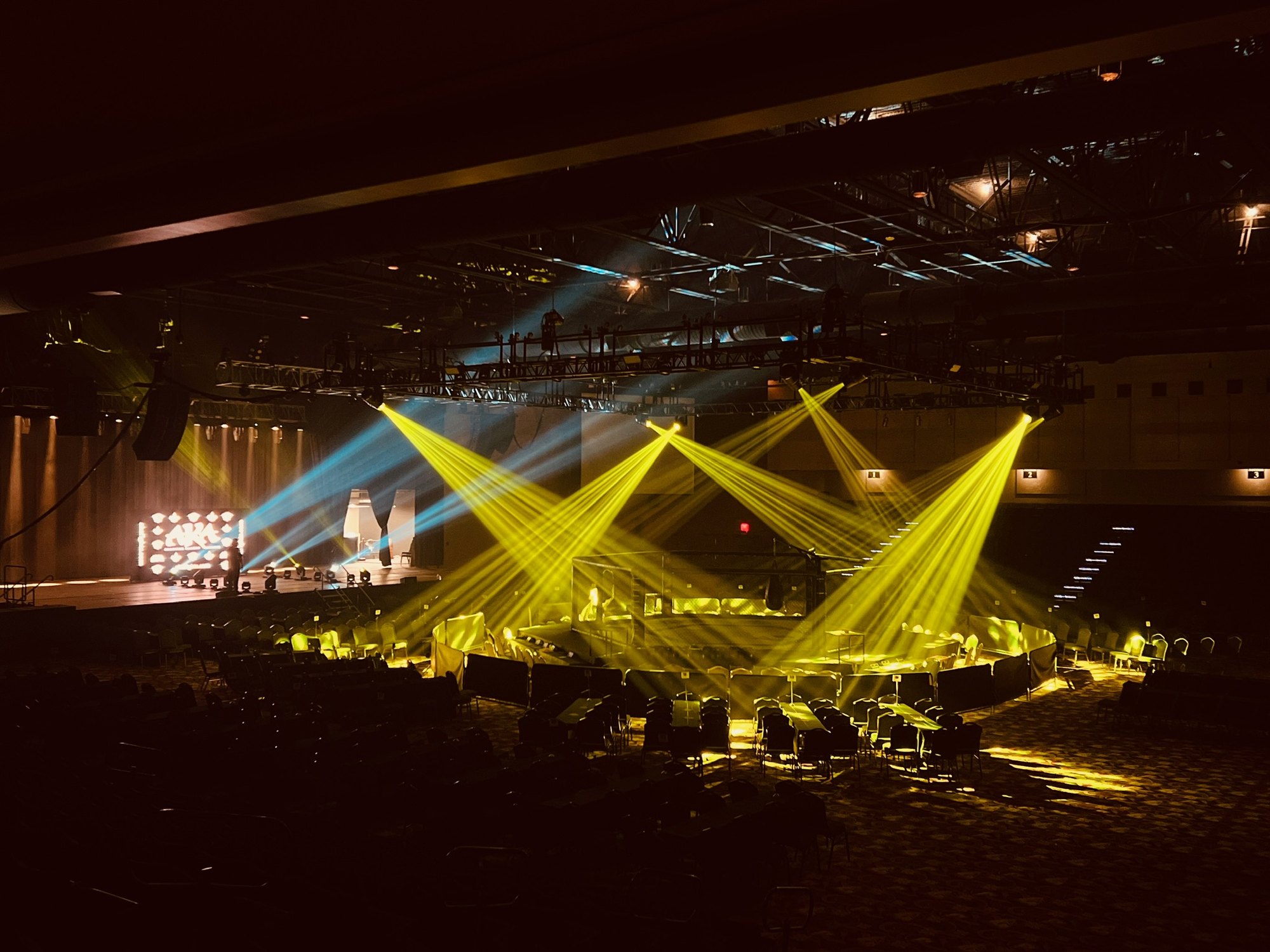 Gold light beams fanned out over an arena crowd, Deep South Productions lighting