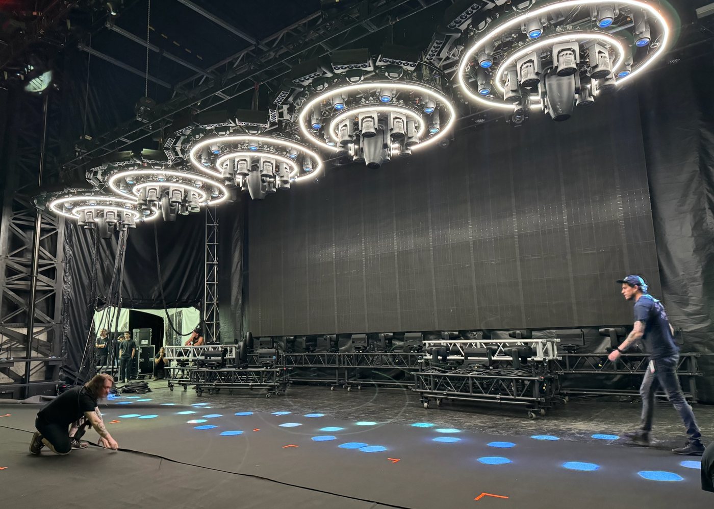 Lighting rig and truss with crew working overhead at an arena, Deep South Productions