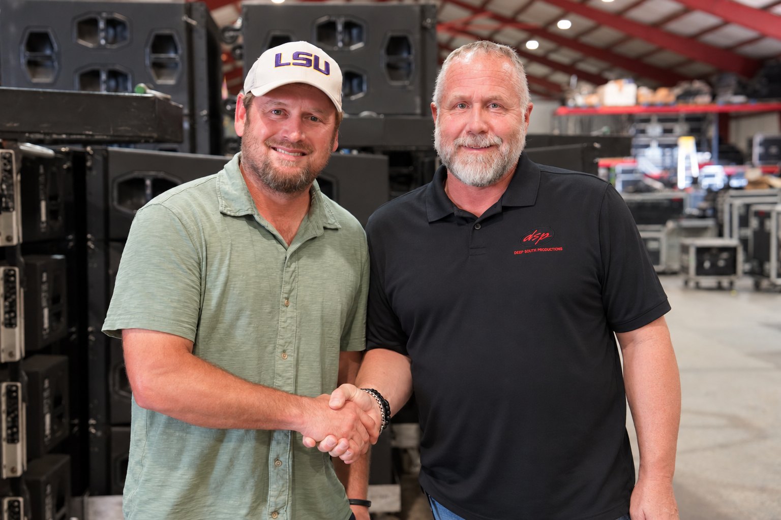 Charles Ducote and Marvin Simon shaking hands in the DSP warehouse