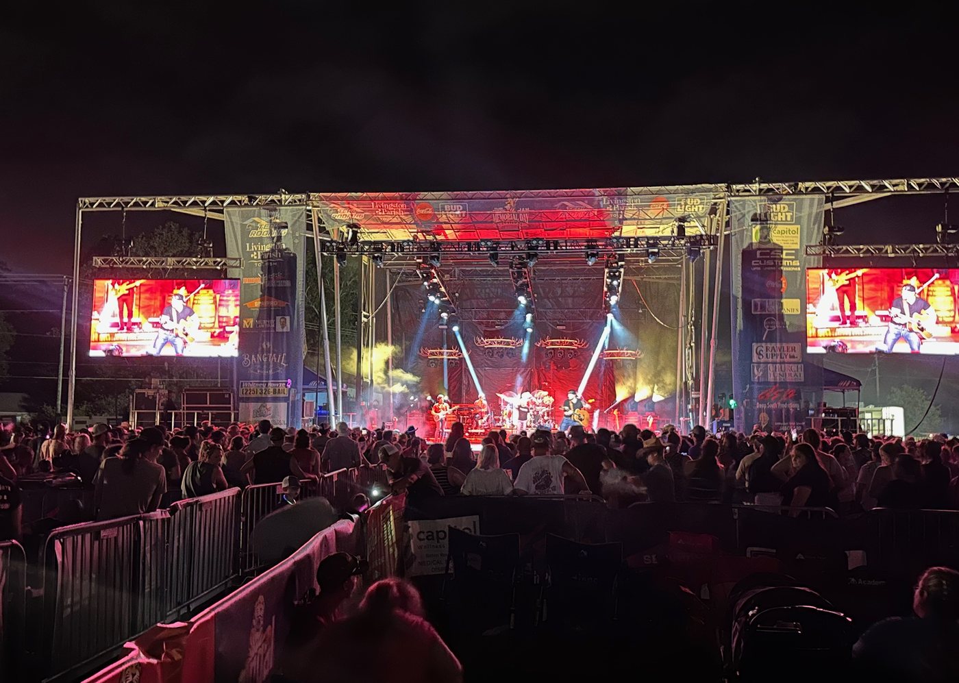 Barricade line in front of a lit festival stage
