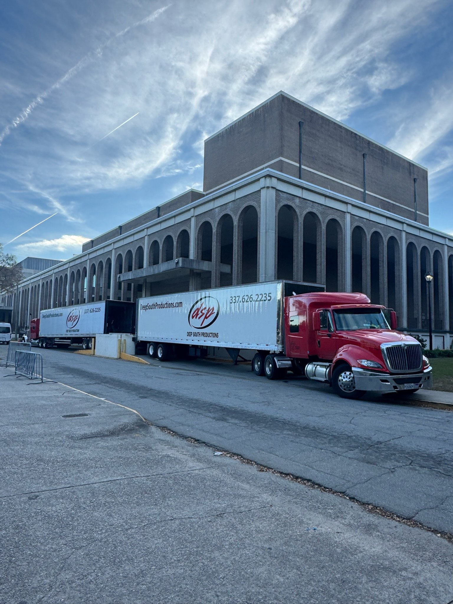 Deep South Productions trucks parked at a downtown venue load-in